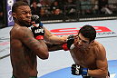 MINNEAPOLIS, MN - OCTOBER 05:  (R-L) Danny Castillo knocks down Michael Johnson with a punch during their lightweight fight at the UFC on FX event at Target Center on October 5, 2012 in Minneapolis, Minnesota.  (Photo by Josh Hedges/Zuffa LLC/Zuffa LLC via Getty Images)