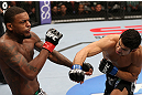 MINNEAPOLIS, MN - OCTOBER 05:  (R-L) Danny Castillo knocks down Michael Johnson with a punch during their lightweight fight at the UFC on FX event at Target Center on October 5, 2012 in Minneapolis, Minnesota.  (Photo by Josh Hedges/Zuffa LLC/Zuffa LLC via Getty Images)