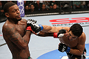 MINNEAPOLIS, MN - OCTOBER 05:  (R-L) Danny Castillo knocks down Michael Johnson with a punch during their lightweight fight at the UFC on FX event at Target Center on October 5, 2012 in Minneapolis, Minnesota.  (Photo by Josh Hedges/Zuffa LLC/Zuffa LLC via Getty Images)