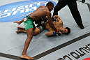 MINNEAPOLIS, MN - OCTOBER 05:  (L-R) Michael Johnson knocks out Danny Castillo with a series of punches during their lightweight fight at the UFC on FX event at Target Center on October 5, 2012 in Minneapolis, Minnesota.  (Photo by Josh Hedges/Zuffa LLC/Zuffa LLC via Getty Images)