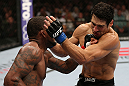 MINNEAPOLIS, MN - OCTOBER 05:  (L-R) Michael Johnson knocks out Danny Castillo with a series of punches during their lightweight fight at the UFC on FX event at Target Center on October 5, 2012 in Minneapolis, Minnesota.  (Photo by Josh Hedges/Zuffa LLC/Zuffa LLC via Getty Images)