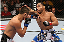 MINNEAPOLIS, MN - OCTOBER 05:  (R-L) John Dodson punches Jussier Formiga during their flyweight fight at the UFC on FX event at Target Center on October 5, 2012 in Minneapolis, Minnesota.  (Photo by Josh Hedges/Zuffa LLC/Zuffa LLC via Getty Images)