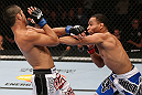 MINNEAPOLIS, MN - OCTOBER 05:  (R-L) John Dodson punches Jussier Formiga during their flyweight fight at the UFC on FX event at Target Center on October 5, 2012 in Minneapolis, Minnesota.  (Photo by Josh Hedges/Zuffa LLC/Zuffa LLC via Getty Images)