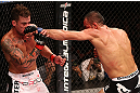 RIO DE JANEIRO, BRAZIL - OCTOBER 13:  (R-L) Reza Madadi punches Cristiano Marcello during their lightweight fight at UFC 153 inside HSBC Arena on October 13, 2012 in Rio de Janeiro, Brazil.  (Photo by Josh Hedges/Zuffa LLC/Zuffa LLC via Getty Images)