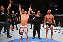 RIO DE JANEIRO, BRAZIL - OCTOBER 13:  Cristiano Marcello (L) reacts after defeating Reza Madadi during their lightweight fight at UFC 153 inside HSBC Arena on October 13, 2012 in Rio de Janeiro, Brazil.  (Photo by Josh Hedges/Zuffa LLC/Zuffa LLC via Getty Images)
