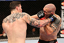RIO DE JANEIRO, BRAZIL - OCTOBER 13:  (L-R) Chris Camozzi punches Luiz Cane during their middleweight fight at UFC 153 inside HSBC Arena on October 13, 2012 in Rio de Janeiro, Brazil.  (Photo by Josh Hedges/Zuffa LLC/Zuffa LLC via Getty Images)