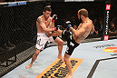 RIO DE JANEIRO, BRAZIL - OCTOBER 13:  (R-L) Sam Sicilia kicks Rony "Jason" Mariano Bezerra during their featherweight fight at UFC 153 inside HSBC Arena on October 13, 2012 in Rio de Janeiro, Brazil.  (Photo by Josh Hedges/Zuffa LLC/Zuffa LLC via Getty Images)