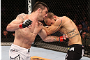 RIO DE JANEIRO, BRAZIL - OCTOBER 13:  (L-R) Rony "Jason" Mariano Bezerra punches Sam Sicilia during their featherweight fight at UFC 153 inside HSBC Arena on October 13, 2012 in Rio de Janeiro, Brazil.  (Photo by Josh Hedges/Zuffa LLC/Zuffa LLC via Getty Images)