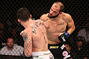 RIO DE JANEIRO, BRAZIL - OCTOBER 13:  (L-R) Rony "Jason" Mariano Bezerra punches Sam Sicilia during their featherweight fight at UFC 153 inside HSBC Arena on October 13, 2012 in Rio de Janeiro, Brazil.  (Photo by Josh Hedges/Zuffa LLC/Zuffa LLC via Getty Images)