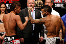 MACAU, MACAU - NOVEMBER 09:  (L-R) Opponents Yasuhiro Urushitani and John Lineker face off during the UFC Macau weigh in at Cotai Arena on November 9, 2012 in Macau, Macau.  (Photo by Josh Hedges/Zuffa LLC/Zuffa LLC via Getty Images)