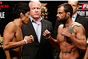 MACAU, MACAU - NOVEMBER 09:  (L-R) Opponents Takeya Mizugaki and Jeff Hougland face off during the UFC Macau weigh in at Cotai Arena on November 9, 2012 in Macau, Macau.  (Photo by Josh Hedges/Zuffa LLC/Zuffa LLC via Getty Images)
