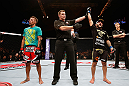 MACAU, MACAU - NOVEMBER 10: John Lineker (R) reacts after defeating Yasuhiro Urushitani (L) during their flyweight bout at the UFC Macao event inside CotaiArena on November 10, 2012 in Macau, Macau. (Photo by Josh Hedges/Zuffa LLC/Zuffa LLC via Getty Images)