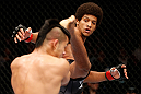 MACAU, MACAU - NOVEMBER 10:  (R-L) Alex Caceres kicks Motonobu Tezuka during their bantamweight bout at the UFC Macao event inside CotaiArena on November 10, 2012 in Macau, Macau.  (Photo by Josh Hedges/Zuffa LLC/Zuffa LLC via Getty Images)