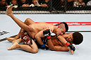 MACAU, MACAU - NOVEMBER 10:  (R-L) Alex Caceres delivers an elbow strike against Motonobu Tezuka during their bantamweight bout at the UFC Macao event inside CotaiArena on November 10, 2012 in Macau, Macau.  (Photo by Josh Hedges/Zuffa LLC/Zuffa LLC via Getty Images)