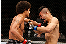 MACAU, MACAU - NOVEMBER 10:  (L-R) Alex Caceres punches Motonobu Tezuka during their bantamweight bout at the UFC Macao event inside CotaiArena on November 10, 2012 in Macau, Macau.  (Photo by Josh Hedges/Zuffa LLC/Zuffa LLC via Getty Images)
