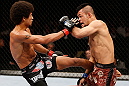 MACAU, MACAU - NOVEMBER 10:  (L-R) Alex Caceres kicks Motonobu Tezuka during their bantamweight bout at the UFC Macao event inside CotaiArena on November 10, 2012 in Macau, Macau.  (Photo by Josh Hedges/Zuffa LLC/Zuffa LLC via Getty Images)