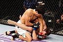 MACAU, MACAU - NOVEMBER 10:  (L-R) Takeya Mizugaki punches Jeff Hougland during their bantamweight bout at the UFC Macao event inside CotaiArena on November 10, 2012 in Macau, Macau.  (Photo by Josh Hedges/Zuffa LLC/Zuffa LLC via Getty Images)