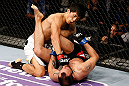 MACAU, MACAU - NOVEMBER 10:  (L-R) Takeya Mizugaki punches Jeff Hougland during their bantamweight bout at the UFC Macao event inside CotaiArena on November 10, 2012 in Macau, Macau.  (Photo by Josh Hedges/Zuffa LLC/Zuffa LLC via Getty Images)