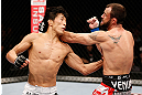 MACAU, MACAU - NOVEMBER 10:  (L-R) Takeya Mizugaki punches Jeff Hougland during their bantamweight bout at the UFC Macao event inside CotaiArena on November 10, 2012 in Macau, Macau.  (Photo by Josh Hedges/Zuffa LLC/Zuffa LLC via Getty Images)
