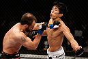 MACAU, MACAU - NOVEMBER 10:  (R-L) Takeya Mizugaki punches Jeff Hougland during their bantamweight bout at the UFC Macao event inside CotaiArena on November 10, 2012 in Macau, Macau.  (Photo by Josh Hedges/Zuffa LLC/Zuffa LLC via Getty Images)