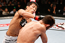 MACAU, MACAU - NOVEMBER 10:  (L-R) Takeya Mizugaki punches Jeff Hougland during their bantamweight bout at the UFC Macao event inside CotaiArena on November 10, 2012 in Macau, Macau.  (Photo by Josh Hedges/Zuffa LLC/Zuffa LLC via Getty Images)