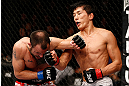 MACAU, MACAU - NOVEMBER 10:  (R-L) Takeya Mizugaki punches Jeff Hougland during their bantamweight bout at the UFC Macao event inside CotaiArena on November 10, 2012 in Macau, Macau.  (Photo by Josh Hedges/Zuffa LLC/Zuffa LLC via Getty Images)