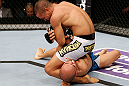 MACAU, MACAU - NOVEMBER 10: (L-R) Jon Tuck attempts an arm bar submission against Tiequan Zhang during their lightweight bout at the UFC Macao event inside CotaiArena on November 10, 2012 in Macau, Macau. (Photo by Josh Hedges/Zuffa LLC/Zuffa LLC via Getty Images)