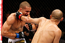 MACAU, MACAU - NOVEMBER 10: (R-L) Tiequan Zhang punches Jon Tuck during their lightweight bout at the UFC Macao event inside CotaiArena on November 10, 2012 in Macau, Macau. (Photo by Josh Hedges/Zuffa LLC/Zuffa LLC via Getty Images)