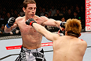 MACAU, MACAU - NOVEMBER 10: (L-R) Mac Danzig punches Takanori Gomi during their lightweight bout at the UFC Macao event inside CotaiArena on November 10, 2012 in Macau, Macau. (Photo by Josh Hedges/Zuffa LLC/Zuffa LLC via Getty Images)