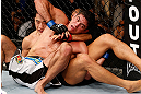 MACAU, MACAU - NOVEMBER 10: (R-L) Paulo Thiago and Dong Hyun Kim grapple for position during their welterweight bout at the UFC Macao event inside CotaiArena on November 10, 2012 in Macau, Macau. (Photo by Josh Hedges/Zuffa LLC/Zuffa LLC via Getty Images)