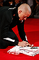 MONTREAL, CANADA - NOVEMBER 15:  Georges St-Pierre signs an autograph in the Octagon during an open training session ahead of UFC 154 at New City Gas on November 15, 2012 in Montreal, Quebec, Canada.  (Photo by Josh Hedges/Zuffa LLC/Zuffa LLC via Getty Images)