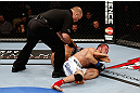 MONTREAL, QC - NOVEMBER 17:  Azamat Gashimov (R) taps out after being put in an arm bar by Ivan Menjivar in their bantamweight bout during UFC 154 on November 17, 2012  at the Bell Centre in Montreal, Canada.  (Photo by Josh Hedges/Zuffa LLC/Zuffa LLC via Getty Images)