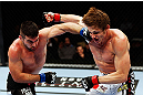MONTREAL, QC - NOVEMBER 17:  John Maguire (L) and Matthew Riddle throw punches at each other in their welterweight bout during UFC 154 on November 17, 2012  at the Bell Centre in Montreal, Canada.  (Photo by Josh Hedges/Zuffa LLC/Zuffa LLC via Getty Images)