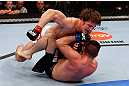 MONTREAL, QC - NOVEMBER 17:  Matthew Riddle (L) throw punch while on top of John Maguire in their welterweight bout during UFC 154 on November 17, 2012  at the Bell Centre in Montreal, Canada.  (Photo by Josh Hedges/Zuffa LLC/Zuffa LLC via Getty Images)