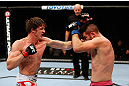MONTREAL, QC - NOVEMBER 17:  John Maguire (R) tries to block a punch thown by Matthew Riddle in their welterweight bout during UFC 154 on November 17, 2012  at the Bell Centre in Montreal, Canada.  (Photo by Josh Hedges/Zuffa LLC/Zuffa LLC via Getty Images)