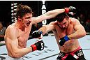 MONTREAL, QC - NOVEMBER 17:  John Maguire (L) and Matthew Riddle throw punches at each other in their welterweight bout during UFC 154 on November 17, 2012  at the Bell Centre in Montreal, Canada.  (Photo by Josh Hedges/Zuffa LLC/Zuffa LLC via Getty Images)
