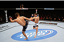 MONTREAL, QC - NOVEMBER 17:  Rodrigo Damm (R) attemps to block the kick of Antonio Carvalho in their featherweight bout during UFC 154 on November 17, 2012  at the Bell Centre in Montreal, Canada.  (Photo by Josh Hedges/Zuffa LLC/Zuffa LLC via Getty Images)