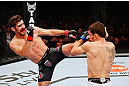MONTREAL, QC - NOVEMBER 17:  Rodrigo Damm (R) attemps to block the kick of Antonio Carvalho in their featherweight bout during UFC 154 on November 17, 2012  at the Bell Centre in Montreal, Canada.  (Photo by Josh Hedges/Zuffa LLC/Zuffa LLC via Getty Images)