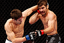 MONTREAL, QC - NOVEMBER 17:  Rodrigo Damm (L) throws a punch against Antonio Carvalho in their featherweight bout during UFC 154 on November 17, 2012  at the Bell Centre in Montreal, Canada.  (Photo by Josh Hedges/Zuffa LLC/Zuffa LLC via Getty Images)
