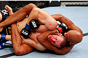 MONTREAL, QC - NOVEMBER 17:  Chad Griggs (L) taps out after being put in a choke hold by Cyrille Diabate in their light heavyweight bout during UFC 154 on November 17, 2012  at the Bell Centre in Montreal, Canada.  (Photo by Josh Hedges/Zuffa LLC/Zuffa LLC via Getty Images)