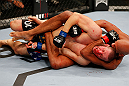 MONTREAL, QC - NOVEMBER 17:  Chad Griggs taps out after being put in a choke hold by Cyrille Diabate in their light heavyweight bout during UFC 154 on November 17, 2012  at the Bell Centre in Montreal, Canada.  (Photo by Josh Hedges/Zuffa LLC/Zuffa LLC via Getty Images)