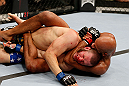 MONTREAL, QC - NOVEMBER 17:  Chad Griggs taps out after being put in a choke hold by Cyrille Diabate in their light heavyweight bout during UFC 154 on November 17, 2012  at the Bell Centre in Montreal, Canada.  (Photo by Josh Hedges/Zuffa LLC/Zuffa LLC via Getty Images)