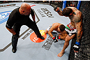 MONTREAL, QC - NOVEMBER 17:  Alessio Sakara (R) punches Patrick Cote in the back of the head as referee Dan Miragliotta looks on during their middleweight bout during UFC 154 on November 17, 2012  at the Bell Centre in Montreal, Canada. Sakara was later disqualified for the illegal punches.  (Photo by Josh Hedges/Zuffa LLC/Zuffa LLC via Getty Images)