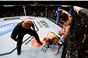 MONTREAL, QC - NOVEMBER 17:  Alessio Sakara (R) punches Patrick Cote in the back of the head as referee Dan Miragliotta looks on during their middleweight bout during UFC 154 on November 17, 2012  at the Bell Centre in Montreal, Canada. Sakara was later disqualified for the illegal punches.  (Photo by Josh Hedges/Zuffa LLC/Zuffa LLC via Getty Images)