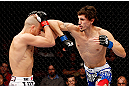MONTREAL, QC - NOVEMBER 17:  Pablo Garza (R) throws an elbow against Mark Hominick in their featherweight bout during UFC 154 on November 17, 2012  at the Bell Centre in Montreal, Canada.  (Photo by Josh Hedges/Zuffa LLC/Zuffa LLC via Getty Images)