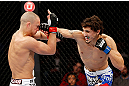 MONTREAL, QC - NOVEMBER 17:  Pablo Garza (R)) connects on a punch against Mark Hominick in their featherweight bout during UFC 154 on November 17, 2012  at the Bell Centre in Montreal, Canada.  (Photo by Josh Hedges/Zuffa LLC/Zuffa LLC via Getty Images)