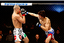 MONTREAL, QC - NOVEMBER 17:  Pablo Garza (R) throws a punch against Mark Hominick in their featherweight bout during UFC 154 on November 17, 2012  at the Bell Centre in Montreal, Canada.  (Photo by Josh Hedges/Zuffa LLC/Zuffa LLC via Getty Images)