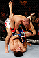 MONTREAL, QC - NOVEMBER 17:  Pablo Garza (blue shorts) grapples against Mark Hominick in their featherweight bout during UFC 154 on November 17, 2012  at the Bell Centre in Montreal, Canada.  (Photo by Josh Hedges/Zuffa LLC/Zuffa LLC via Getty Images)