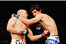 MONTREAL, QC - NOVEMBER 17:  Mark Hominick connects on a punch to the body of Pablo Garza (R) during their featherweight bout during UFC 154 on November 17, 2012  at the Bell Centre in Montreal, Canada.  (Photo by Josh Hedges/Zuffa LLC/Zuffa LLC via Getty Images)