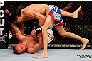 MONTREAL, QC - NOVEMBER 17:  Pablo Garza (R) grapples against Mark Hominick in their featherweight bout during UFC 154 on November 17, 2012  at the Bell Centre in Montreal, Canada.  (Photo by Josh Hedges/Zuffa LLC/Zuffa LLC via Getty Images)